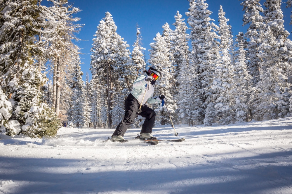 A skier making their way down the slope and enjoying some of the best skiing in New Mexico