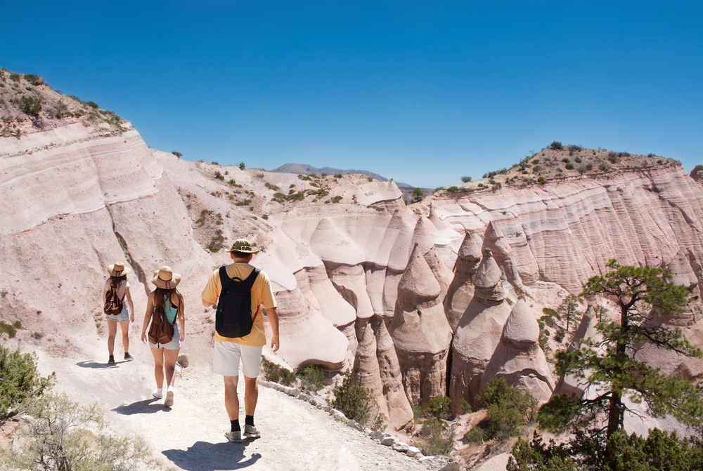 A family hiking through Tent Rocks, one of the best Santa Fe hiking trails