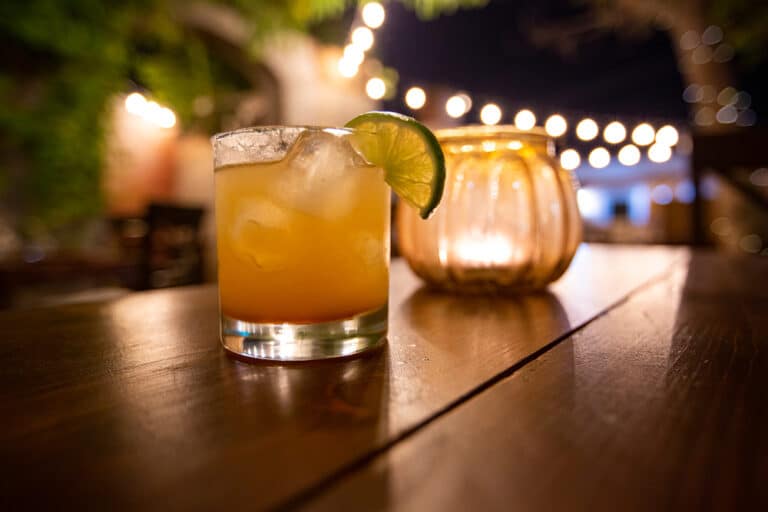 A margarita on the rocks on an outdoor patio, something you can enjoy on the Santa Fe Margarita Trail this summer