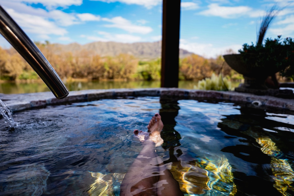 Woman relaxing in warm, soothing waters like those you'll find at Jemez Hot Springs and other New Mexico Hot Springs