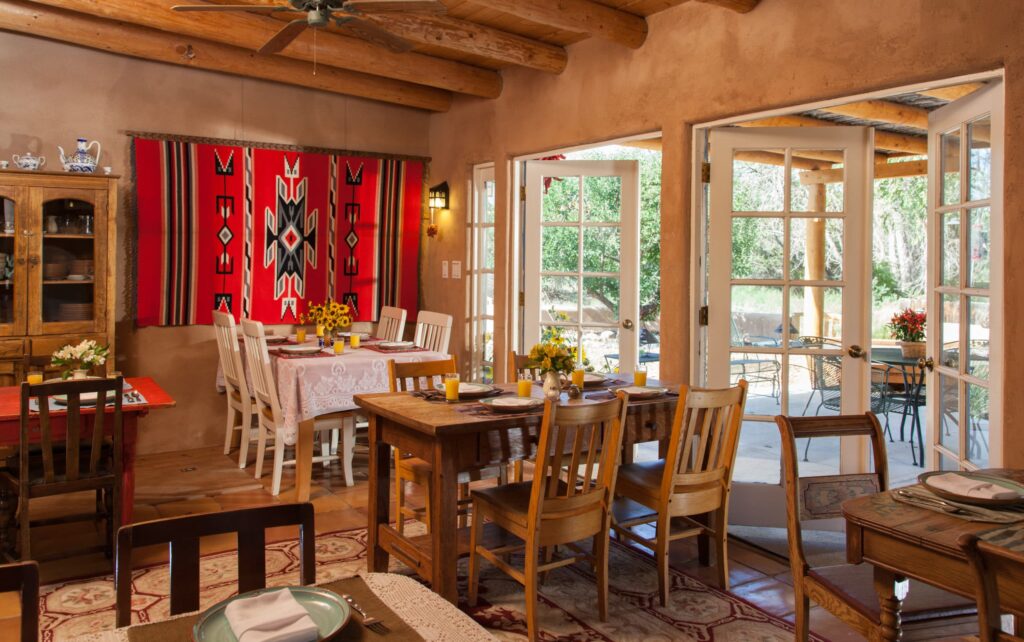 The dining room at Casa Escondida, with gorgeous southwestern decor and french doors leading to an outdoor patio dining area.