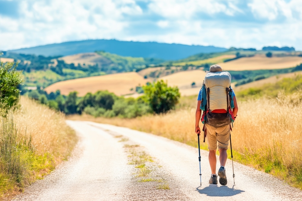 A lonely pilgrim backpacking on his way to El Santuario de Chimayo Church.