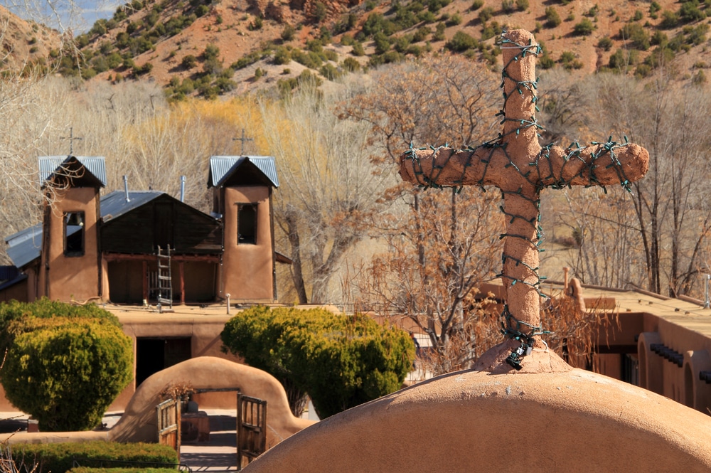 An exterior photo of the historic El Santuario de Chimayo Church in winter.